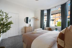 a bedroom with a bed with towels on it at Charming 4BR Retreat in Hull Sleeps 8 by Stay With Us in Hull