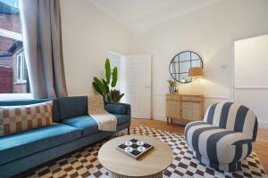 a living room with a blue couch and a chair at Charming 4BR Retreat in Hull Sleeps 8 by Stay With Us in Hull +55 photos