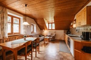 a kitchen and living room with a wooden ceiling at Balsnhof in Chamerau