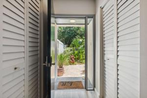 an open door leading to a patio with a plant at 1205 Lagoon Villas in Amelia Island