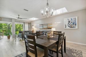 a dining room and living room with a table and chairs at 1205 Lagoon Villas in Amelia Island +41 photos