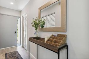 a hallway with a mirror and a table with a basket at 1205 Lagoon Villas in Amelia Island