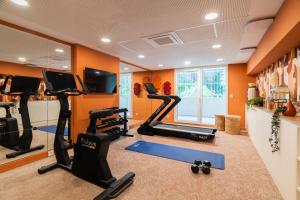 a gym with treadmills and elliptical machines at Appartements Soléo Prado in Marseille
