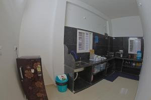 a bathroom with a black counter and a sink at Slackpackr Malakpet Hyderabad in Hyderabad