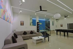 a living room with a couch and a pool table at Slackpackr Malakpet Hyderabad in Hyderabad