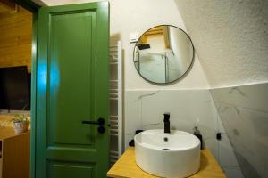 a bathroom with a green door and a sink at DejaView Cabin&Camp in Rogojel +43 photos