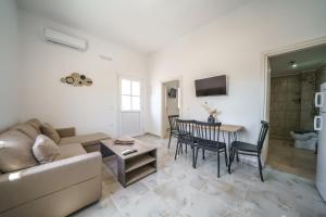 a living room with a couch and a table at Veniro Luxury Apartments in Moírai