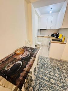 a kitchen with a table and a kitchen with a counter top at 1apartment on First Line-Bosteri in Bosteri