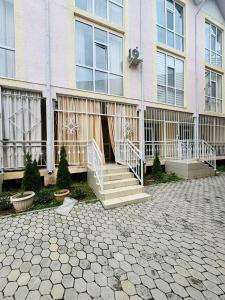 a building with a staircase in front of it at 1apartment on First Line-Bosteri in Bosteri