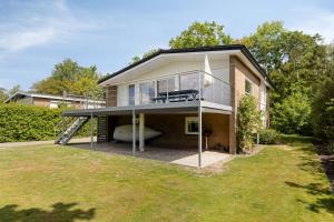 a house with a boat in the front yard at Holidayhouse De Schotsman in Kamperland