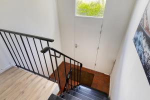 a staircase in a house with a window at Holidayhouse De Schotsman in Kamperland
