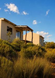 a house sitting on top of a field of grass at Katkop Resort in Graafwater