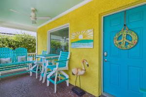 a colorful house with a blue door and chairs at 115 South Fletcher in Fernandina Beach