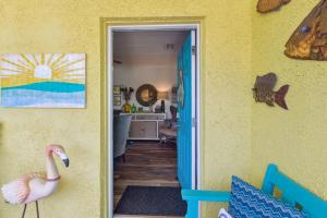 a room with yellow walls and a flamingo standing in the doorway at 115 South Fletcher in Fernandina Beach