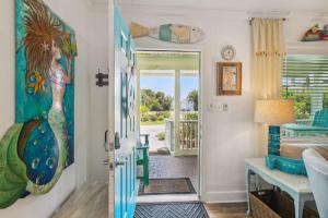 a bathroom with a mermaid painting on the wall at 115 South Fletcher in Fernandina Beach +35 photos
