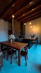 a dining room with a wooden table and chairs at Cabanas Rancho Alcântara in Treviso +20 photos