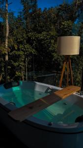 a bath tub with a lamp on top of it at Cabanas Rancho Alcântara in Treviso