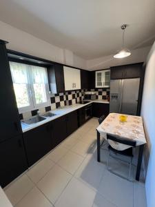 a kitchen with a table and a counter top at Zmarias 1 in Perakhórion +23 photos