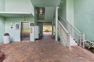 a hallway of a building with a door and stairs at 1321 Shipwatch in Amelia Island