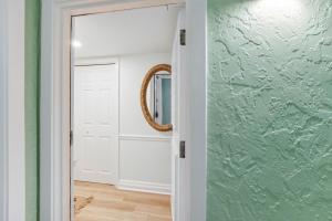 a hallway with a glass door and a mirror at 1321 Shipwatch in Amelia Island