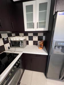 a small kitchen with black and white tile on the wall at Zmarias 1 in Perakhórion