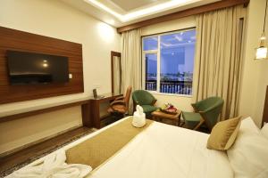 a hotel room with a bed and a window at Trillium Hotel by Stay Sphere in Srinagar