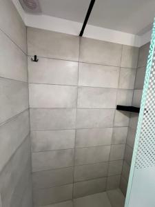 a bathroom with a shower with white tile at Zmarias 1 in Perakhórion