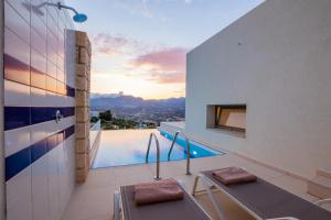 a bathroom with a view of a swimming pool at Renata's Villas in Karpathos