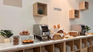 a bakery counter with bread and pastries on it at Hotel Atalaya II in Portonovo