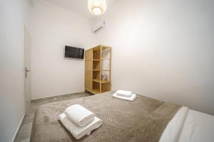 a bedroom with a bed with two towels on it at Veniro Luxury Apartments in Moírai +81 photos