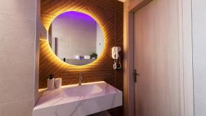 a bathroom with a sink and a mirror at Troy Seaside in Paralia Katerinis +89 photos