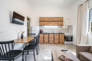 a kitchen and living room with a table and chairs at Veniro Luxury Apartments in Moírai