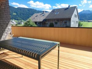 a bench on a deck with a wooden fence at Sonnen Bauernhof Schneider in Meisten