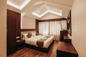 a bedroom with a large bed in a room at Trillium Hotel by Stay Sphere in Srinagar