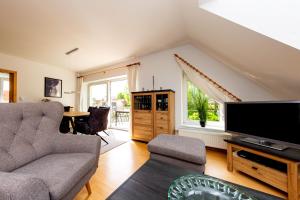 a living room with a couch and a tv at Casa Claudio in Plau am See