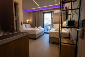 a hotel room with two beds and a sink at Troy Seaside in Paralia Katerinis
