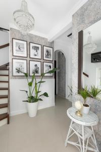 a living room with a table and potted plants at Zwierzyńscy Residence in Pobierowo