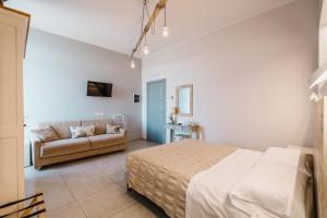 a bedroom with a bed and a couch at Dimora Marinucci in Termoli