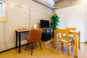 an office with a desk with a computer and chairs at Kokusai Street Garden Hotel in Naha