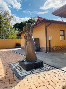 a statue of a woman with her hands in the air at N'taba River Lodge & Spa in Port St. Johns