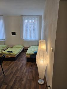 a room with two beds and a lamp in it at Studio Klicperova in Chlumec nad Cidlinou