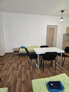 a room with a table and chairs and a bed at Studio Klicperova in Chlumec nad Cidlinou +3 photos