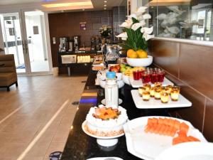 a buffet line with food and drinks in a restaurant at Delfines Collection Hotel by Mercure in Santa Cruz de la Sierra
