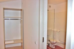a bathroom with a toilet and a glass shower at Central Guesthouse in Bucharest +111 photos