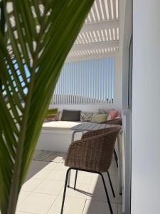 a patio with a bench and a table and a chair at Melina Knossos Iraklio Crete in Áno Fortétsa