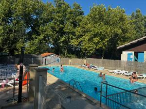 a group of people in a swimming pool at Camping les sablons in Vergeroux