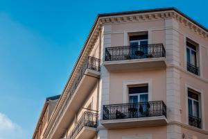 a tall building with balconies on the side of it at Crisol Lumière in Cannes +63 photos