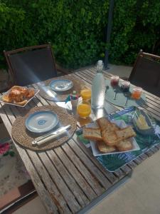 a picnic table with breakfast food on it at Charmante chambre d'hôtes "CARLA" avec piscine, Château de Favas in Bargemon +5 photos