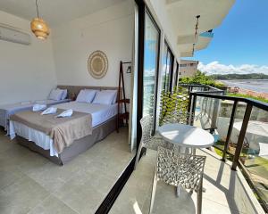 Ένα ή περισσότερα κρεβάτια σε δωμάτιο στο Maraga Bento Hotel