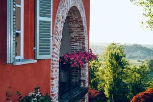 an arched window with flowers on a balcony at Villa Burzio 1899 in Chieri